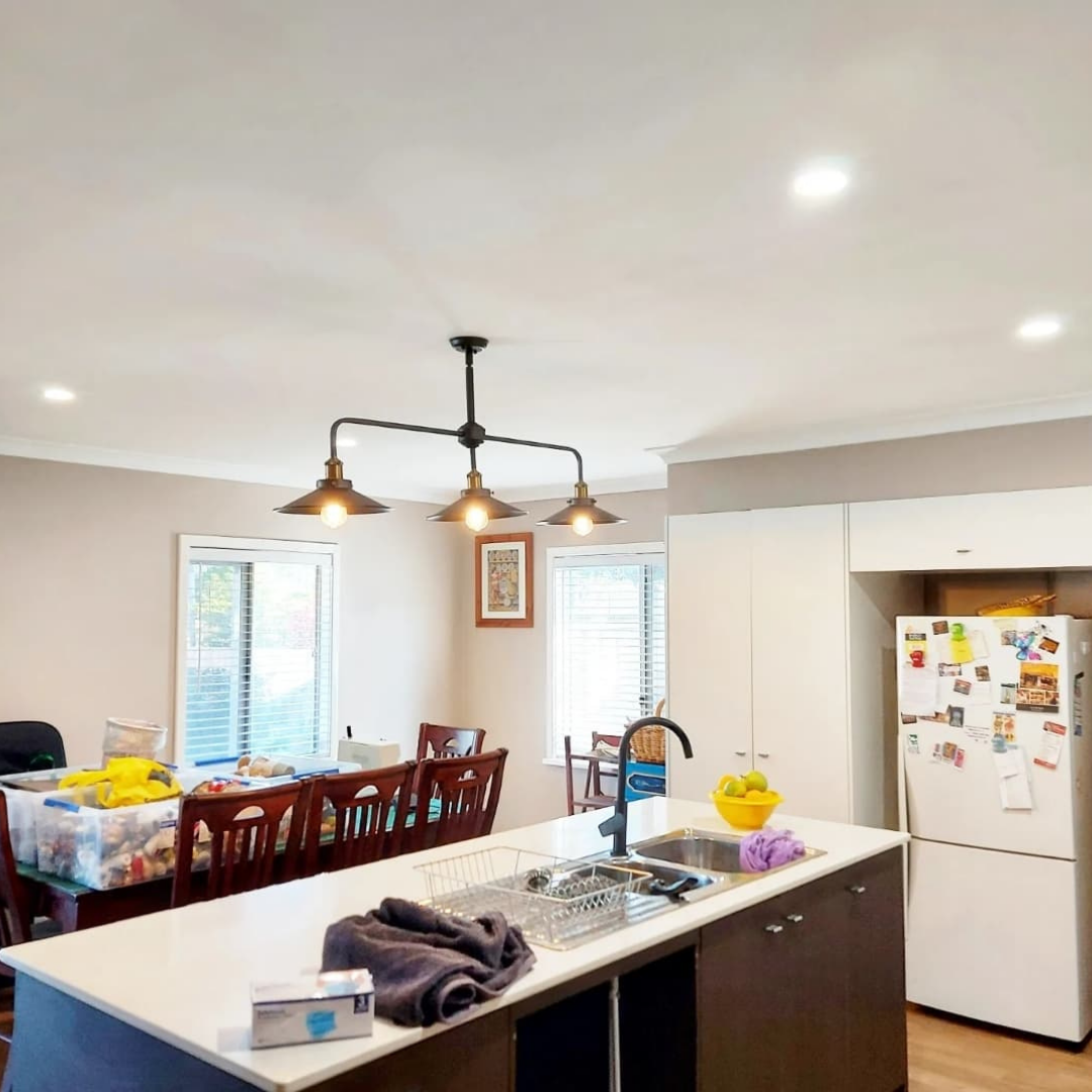 New pendant lighting and LED downlights installed above a kitchen bench
